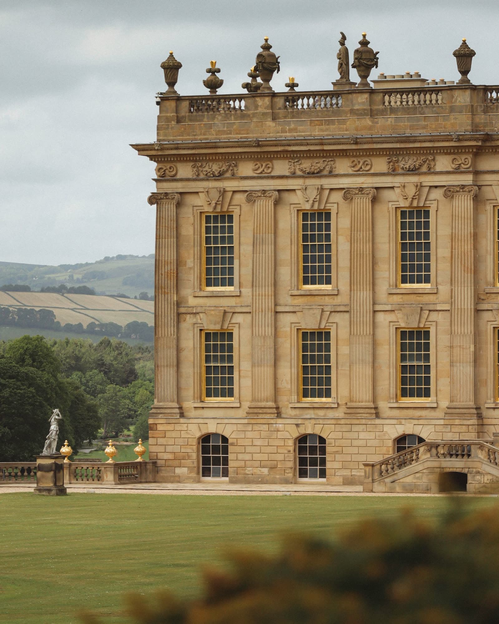A classical stone facade with gilded windows